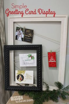 a christmas card display in a frame on top of a box with cards attached to it