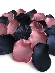 black and pink satin flower petals on white background