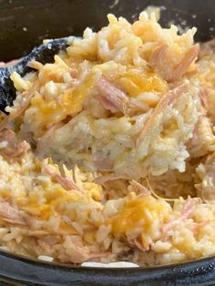 a close up of food in a bowl with a spoon on the top of it