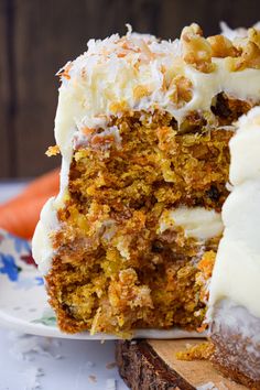 a piece of carrot cake with white frosting on a plate