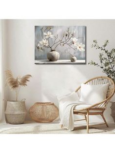 white flowers in vases on a table next to a wicker chair