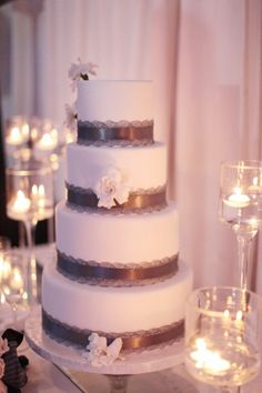 a three tiered wedding cake sitting on top of a table