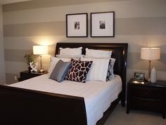 a bedroom with two framed pictures above the bed