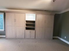 an empty room with some cabinets in it