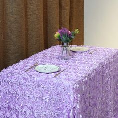 a purple table cloth with flowers on it