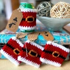 two knitted christmas stockings sitting on top of a table