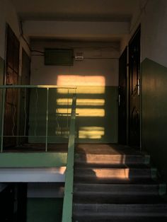 the stairs lead up to an empty room with sunlight coming in through the window and onto the floor