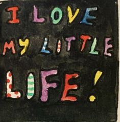 the words i love my little life written on a chalkboard with colored writing in it