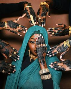 a woman with her hands covered in hennap and tattoos on her face, surrounded by other women's hands