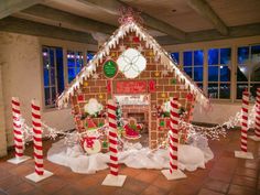 a gingerbread house decorated for christmas with candy canes