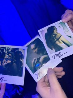 two people holding up polaroid pictures with the same person's name