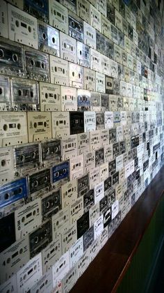 there is a wall with many old cassette tapes on it