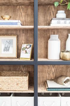 the shelves are filled with books, vases and pictures