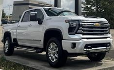 a white truck parked in front of a gas station