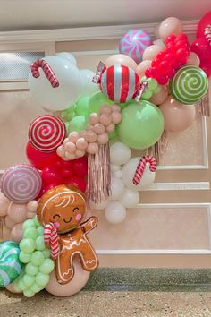 a bunch of balloons that are in the shape of gingerbreads and lollipops