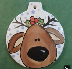 a ceramic ornament with a reindeer's head painted on it