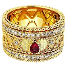 Produced by award winning Italian designer Stefano Vitolo. Stefano creates custom artisanal one of a kind jewelry with excellent gemstones in a truly old world Italian craftmanship. Sophisticated hand engraved design that blends traditional granulation technique with a modern twist. This handcrafted ring has ruby 0.20 carat and diamonds 0.78 carat weight of F/G color, VS clarity diamonds. Luxury Multi-stone Ruby Ring, Luxury Diamond Ring With Decorative Band, Elegant Ceremonial Rings With Gemstone, Luxury Ruby Ring With Diamond Accents, Luxury Ruby Ring With Gemstone Accents For Anniversary, Elegant Ceremonial Gemstone Rings, Luxury Gold Ruby Ring With Accent Stones, Elegant Ceremonial Diamond Ring, Luxury Gold Ruby Ring With Intricate Design