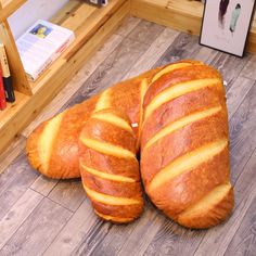 two loaves of bread sitting on the floor