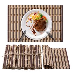 a white plate topped with meat next to a fork and napkin on top of a table