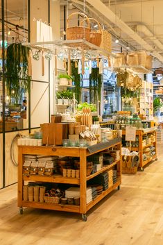 a store filled with lots of different types of food and plants on display in front of glass windows