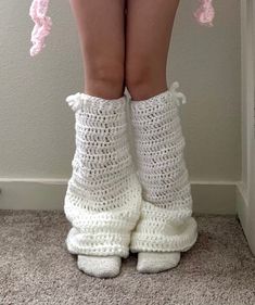 there is a woman's legs with crocheted socks and booties on