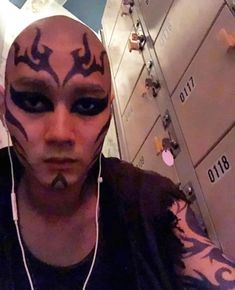 a man with his face painted like a demon