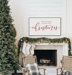 two chairs in front of a fireplace with stockings on the mantle and christmas decorations around it