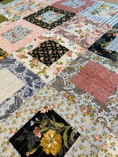 a patchwork quilt is laying on the floor