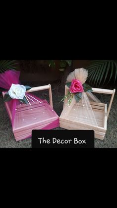 the decor box is pink and white with flowers on it's sides, sitting next to each other