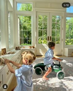 two young children playing with toys in a room