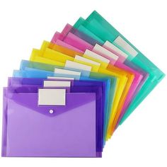 an assortment of colored folders stacked on top of each other