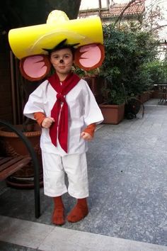 a young boy wearing a costume made to look like a mouse