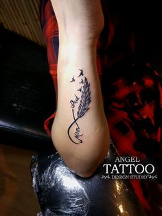 a woman's foot with a tattoo design on the side of her left leg