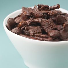 a white bowl filled with chocolate pieces on top of a table