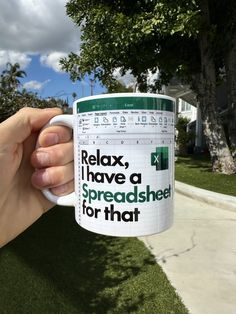 a person holding a coffee mug with the words relax, i have a spreadsheet for that