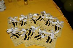 four bees are sitting on top of each other and tied with white ribbon around them