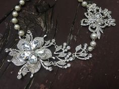 "Perfect for all bridal or party to wear!! Romantic shaped necklace featuring sparkle flower pendants and linked with pearl chains. Color: clear rhinestone crystals with pearls Size: necklace measures around 19.5\" long and large flower pendants around 6\" long x 3.25\" width Item ship out with tracking number to you (around 10 to 14 business days for delivery). We also provide fast shipping service, around 3-4 business days delivery but need to add extra charge. Please convo us if need." Wedding Crystal Necklace With Flower Design, Wedding Crystal Flower Necklace, Pearl Flower Necklace For Wedding, Flower Crystal Wedding Necklace, Wedding Rhinestone Necklace With Pearl Chain, Wedding Pearl Drop Flower Pendant Necklaces, Wedding Pearl Drop Flower Pendant Necklace, Silver Pearl Wedding Necklace With Flower Pendant, Silver Flower Pearl Necklace For Wedding