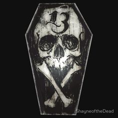 a skull and crossbones carved into a wooden plaque with the number thirteen on it