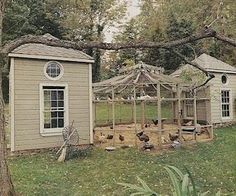 a chicken coop in the backyard with chickens around it and a gazebo on the other side