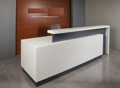 a white reception desk in an office setting