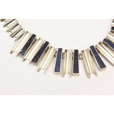 This is part of Chairish’s Fine Jewelry assortment.  This sculptural and fabulous hallmarked vintage sterling silver and lapis lazuli reticulated necklace is quite stunning on. It has a modernist look. This lays well on the neck. They would look great together.This is from the 70's. It is 8" H or Long on your neck and each side is 1.5" D at the widest part. The upper part of only silver is 1/2 inch deep towards the back.  Please reference the measurements noted in the description above for the b Modern Blue Necklace With Polished Finish, Modern Blue Necklaces With Polished Finish, Blue Modernist Jewelry With Polished Finish, Modernist Blue Jewelry With Polished Finish, Modern Lapis Lazuli Jewelry With Polished Finish, Silver Lapis Lazuli Jewelry For Formal Events, Silver Lapis Lazuli Jewelry For Formal Occasions, Formal Silver Lapis Lazuli Jewelry, Modernist Metal Necklace With Polished Finish