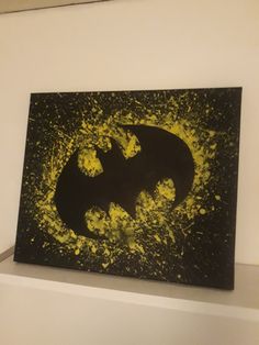 the batman symbol is painted on a black and yellow background