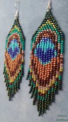 These handmade earrings in the form of peacock feathers are made of high-quality Czech beads and strong synthetic thread. They are elegant, fashionable, and highly versatile, suitable for everyday wear.Peacock is considered to be more of a talisman of glory. Color: Green, purple, turquoise, salat, blue,bronze. . 100% hand made with love! Measurements: Length-10cm,Width -3 cm Materials: Silver plated ear hooks Czech glass beads Nylon Thread Bohemian Peacock Earrings For Gift, Peacock-colored Bohemian Earrings For Gift, Bohemian Peacock Earrings As Gift, Peacock Bohemian Earrings For Gift, Peacock Bohemian Earrings As Gift, Bohemian Green Earrings With Peacock Design, Handmade Bohemian Peacock Earrings, Handmade Peacock Color Bohemian Earrings, Iridescent Earrings