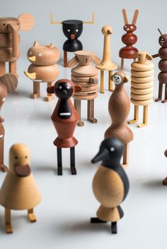 several wooden toy animals standing in front of each other