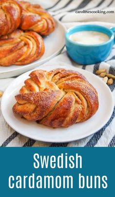 swedish cardamon buns on white plates with blue mug and bowl in background