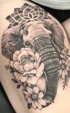 an elephant with flowers on it's thigh is shown in black and grey ink