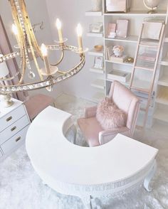 a living room with a chandelier and white furniture