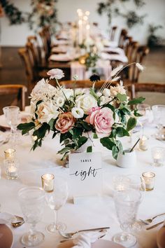 a table with flowers and candles is set up for a formal dinner or reception party