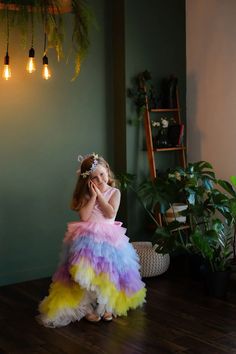 Add a burst of color and magic to your little one's special moments with this vibrant ombre princess gown by Lily Couture. Designed with cascading layers of tulle in soft pastel hues, this dress is a visual delight perfect for flower girls, birthdays, and photoshoots. The sleeveless bodice and oversized back bow create an elegant silhouette that balances charm and comfort. Available in 40 color combinations, this dress ensures your child stands out with a radiant, unforgettable look. Make their Maxi Birthday Dress, Rainbow Tulle Dress, Baby Christening Outfit, Baby Birthday Dress, Pageant Gown, Draping Fashion, Girls Pageant Dresses, Princess Gown, Christening Dress