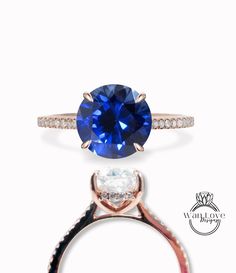 an engagement ring with a blue sapphire and diamonds on the side, set in rose gold